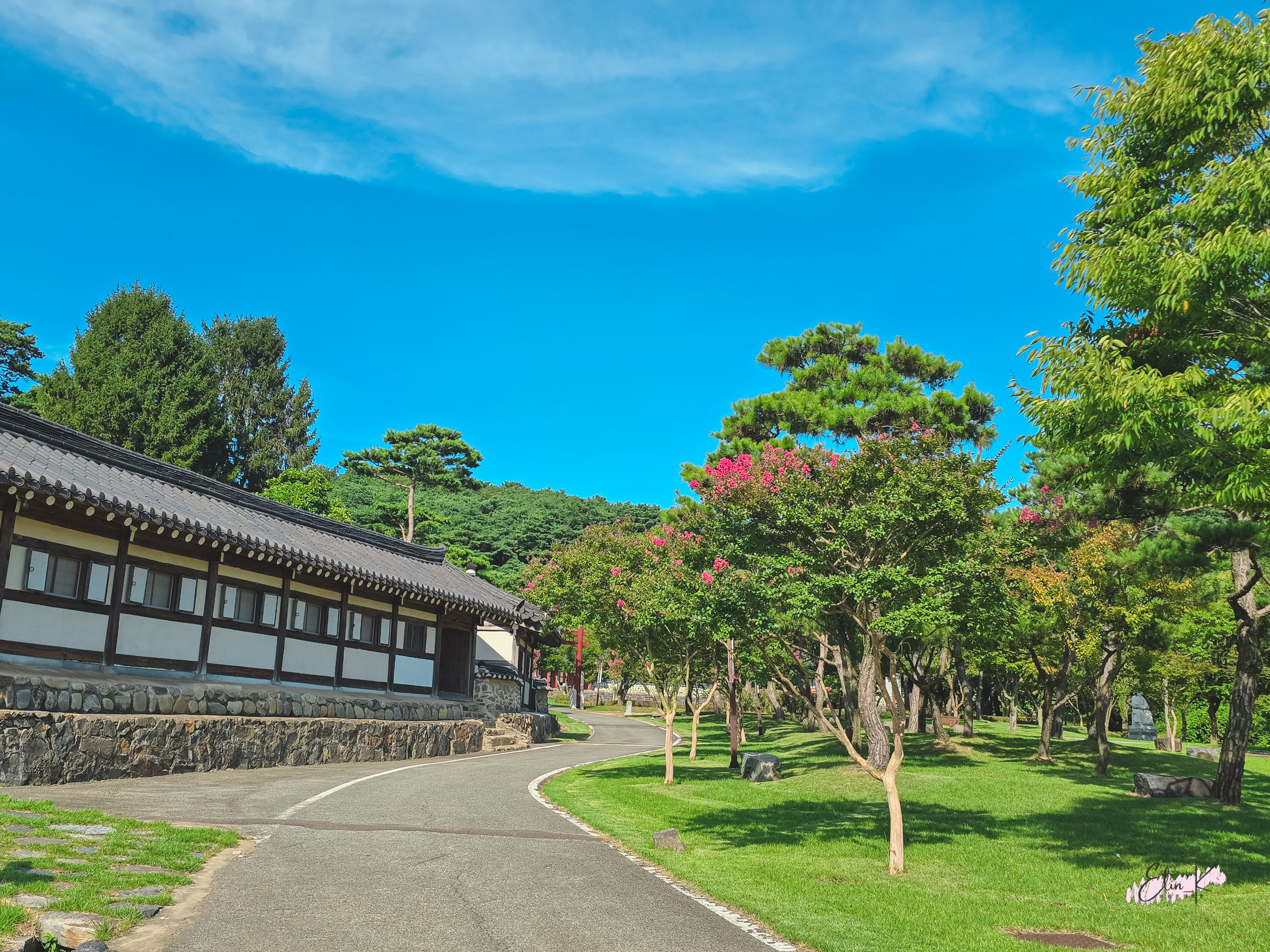 Hotel grounds with traditional buildings and lush trees