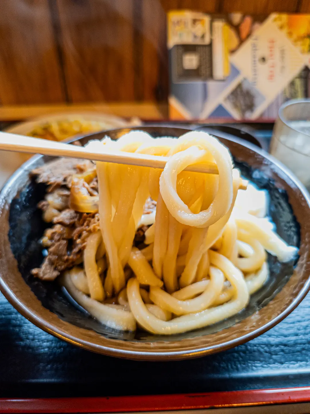 Taking a bite of Niku Bukkake Udon