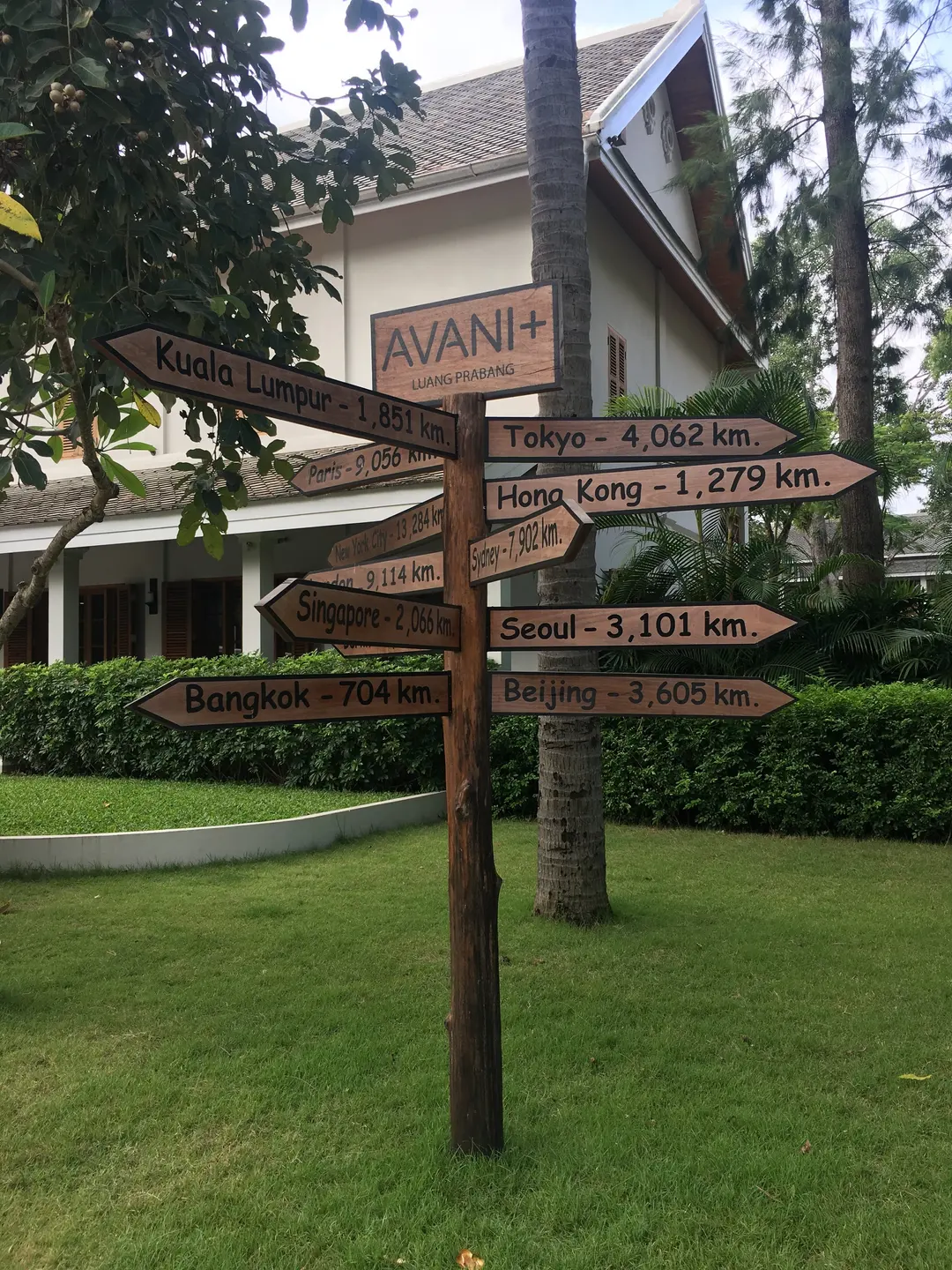 Global distance signpost in Luang Prabang