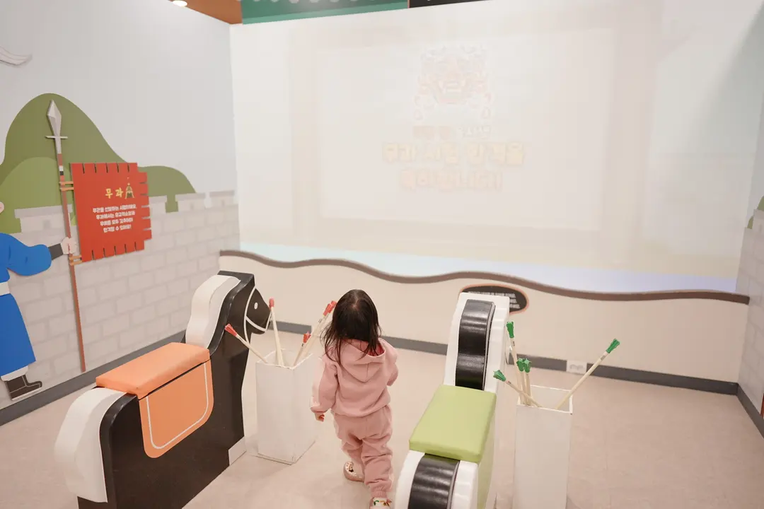 Kids trying the horseback simulator