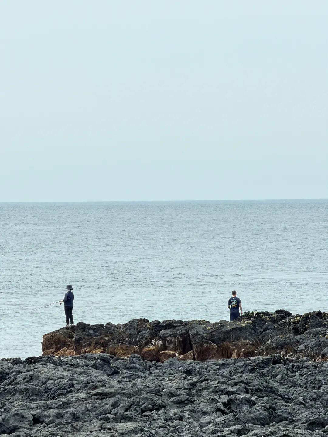 People fishing at Panpo Port during low tide