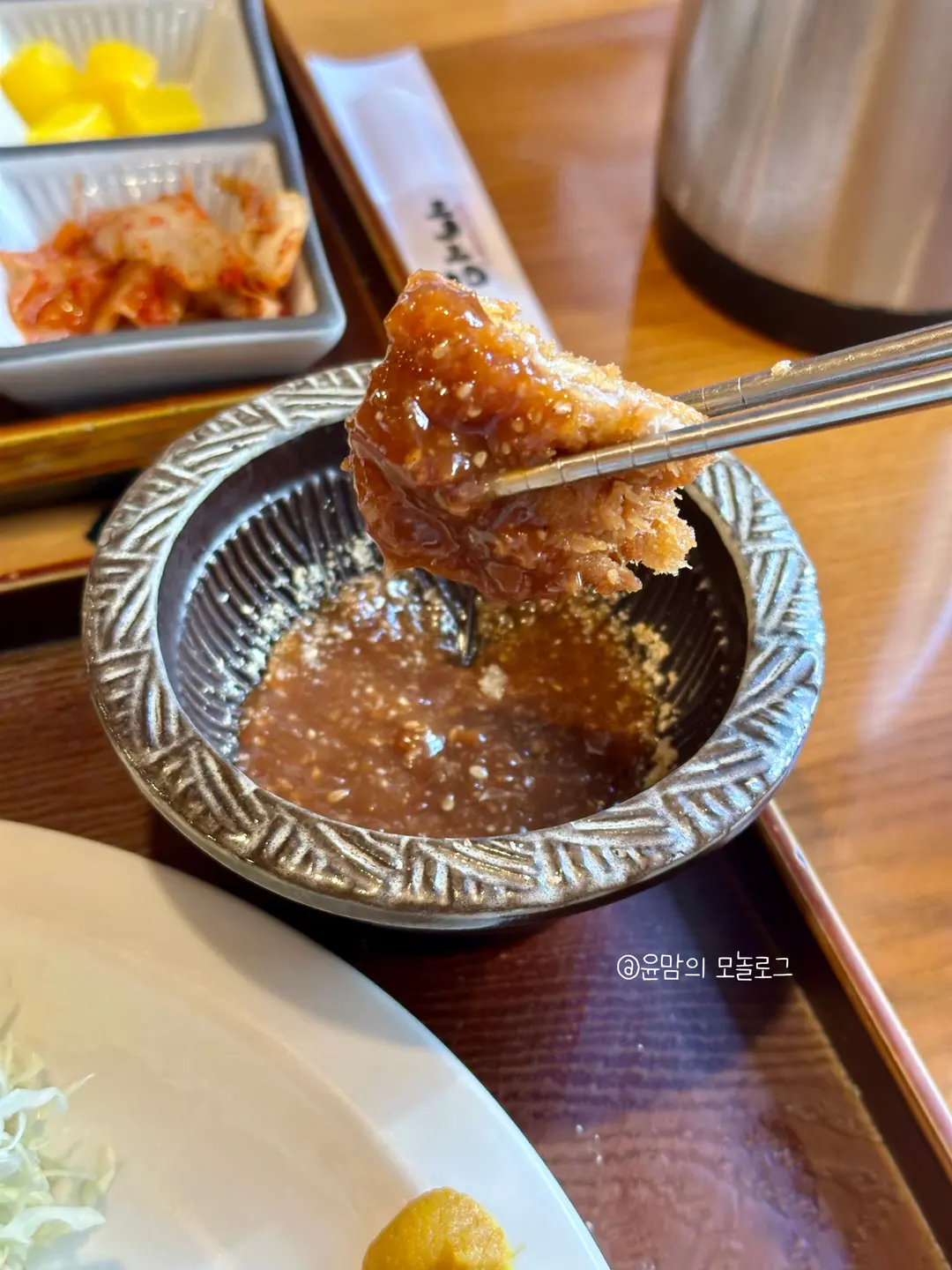 Dipping cheese tonkatsu in sauce