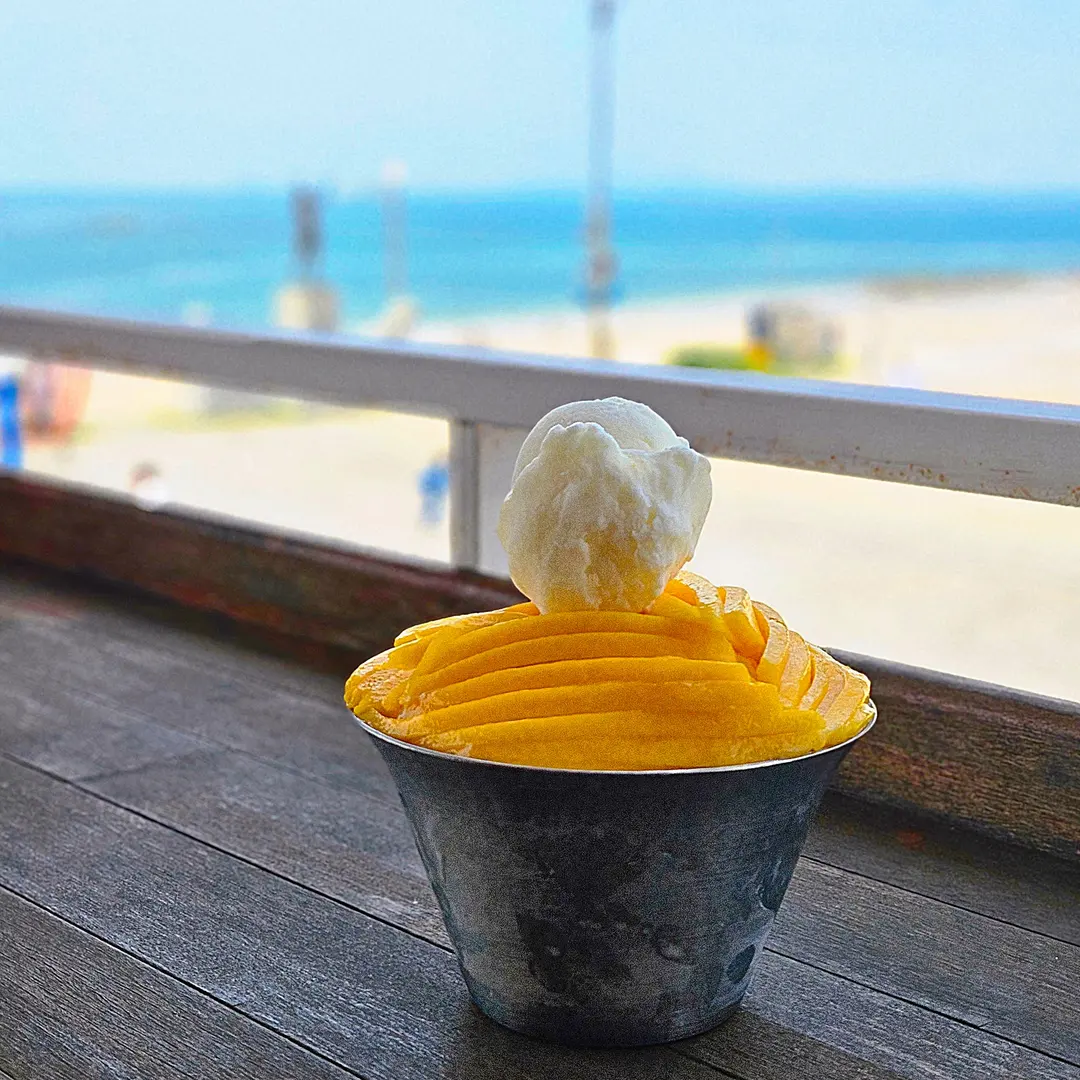 Generous portions of fresh mango slices on shaved ice