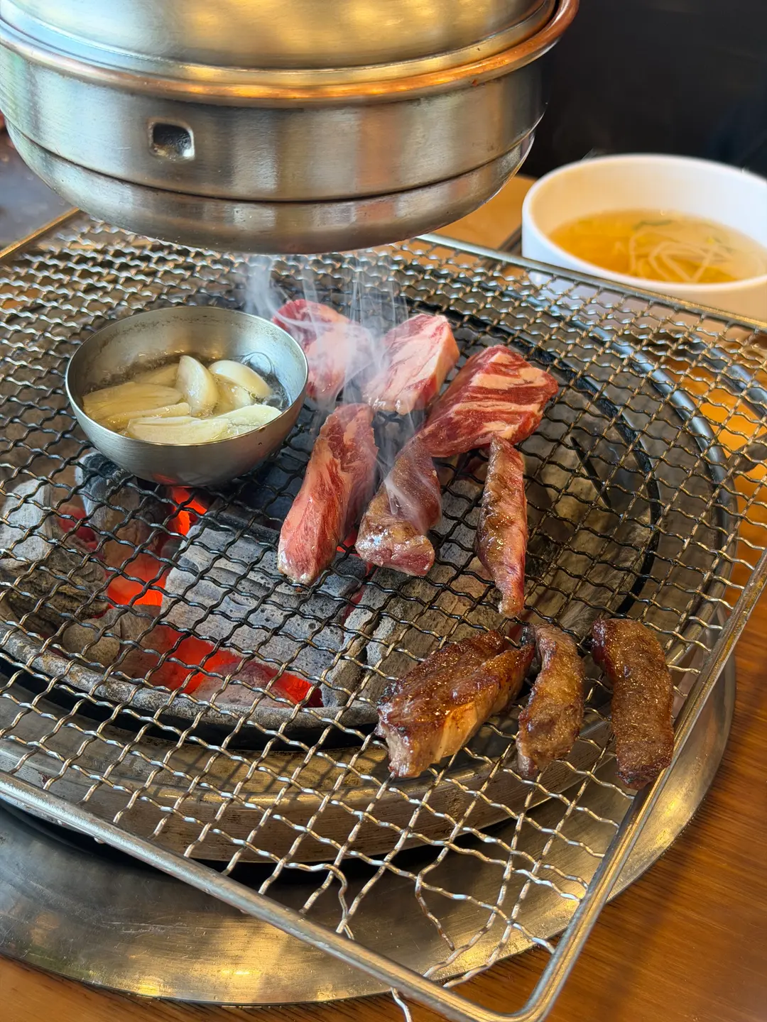 Beef rib grilling over charcoal