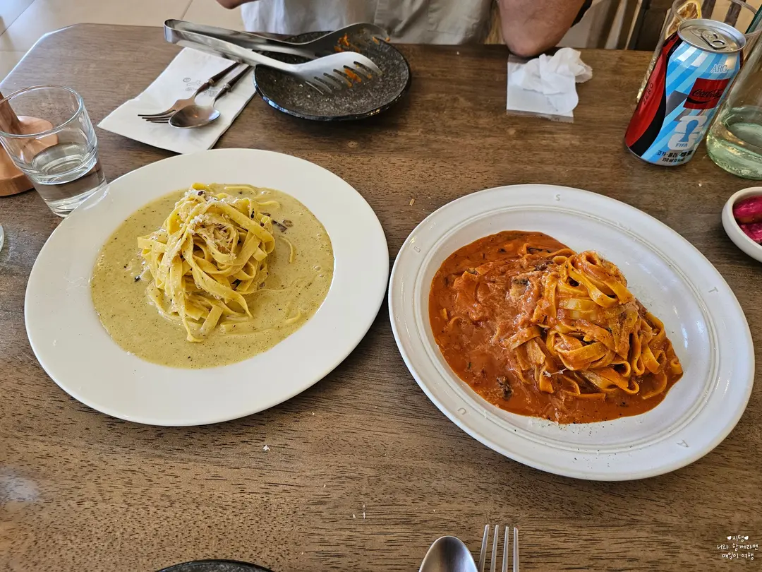 Two plates of pasta side by side