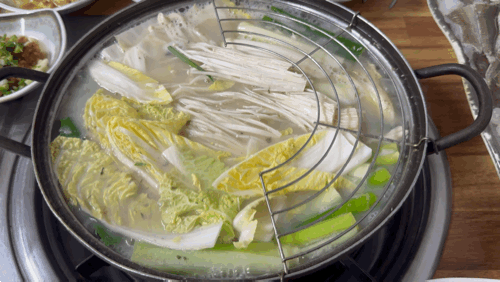 Dipping Hamo into broth