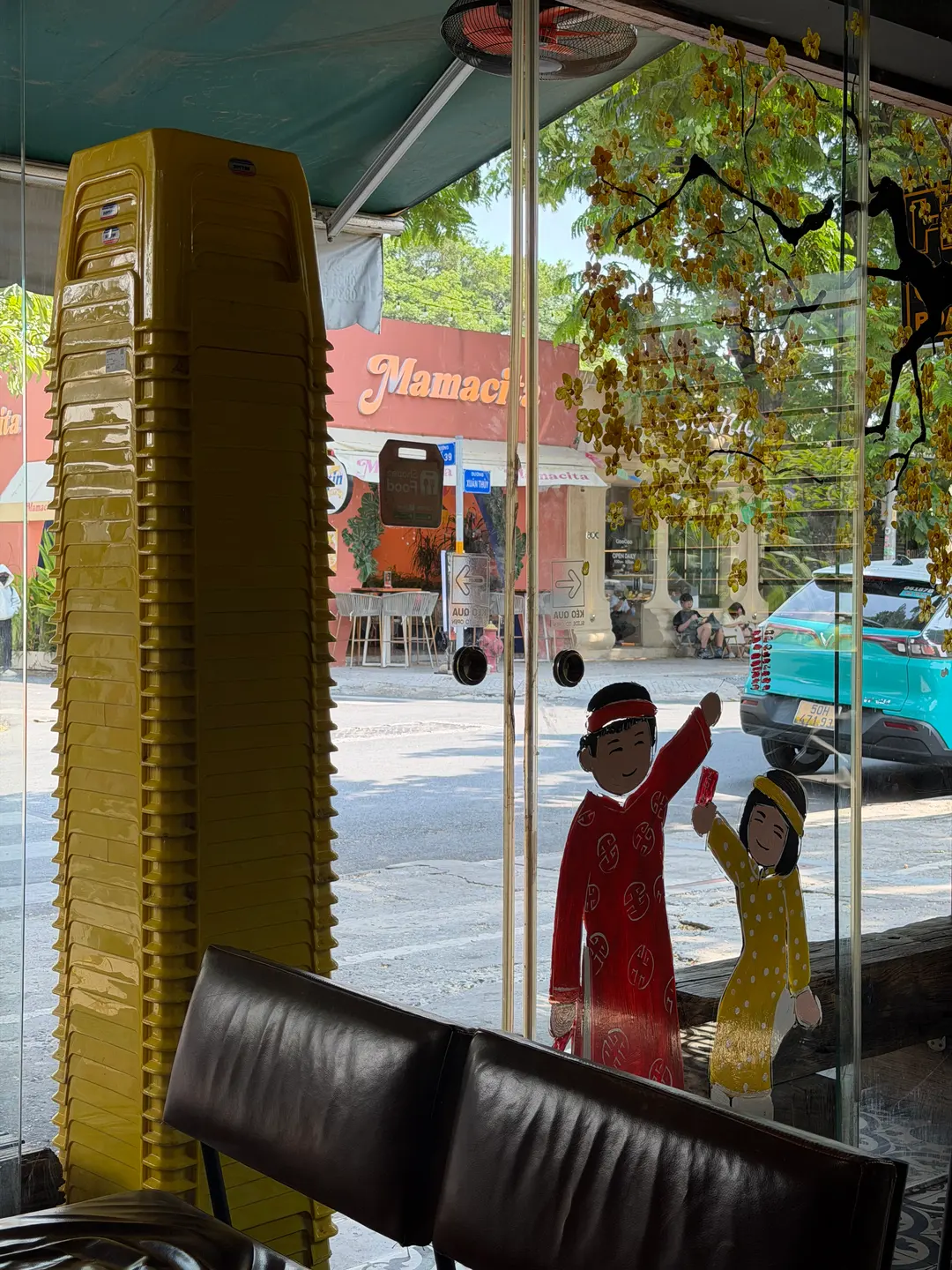 Yellow plastic stools stacked outside