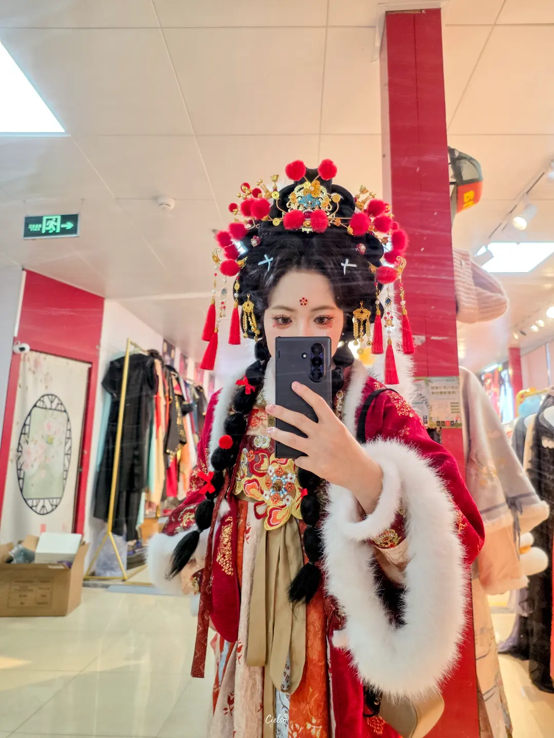 Posing in traditional dress under glowing lanterns