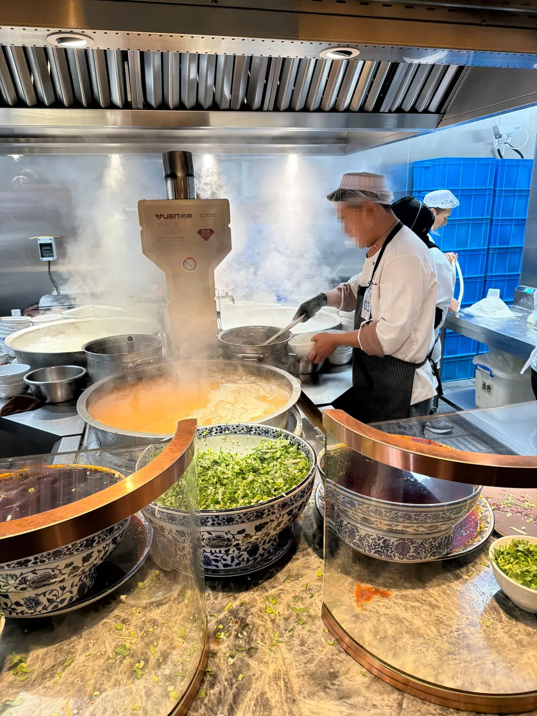 A chef expertly pulling noodles by hand in a Lanzhou restaurant