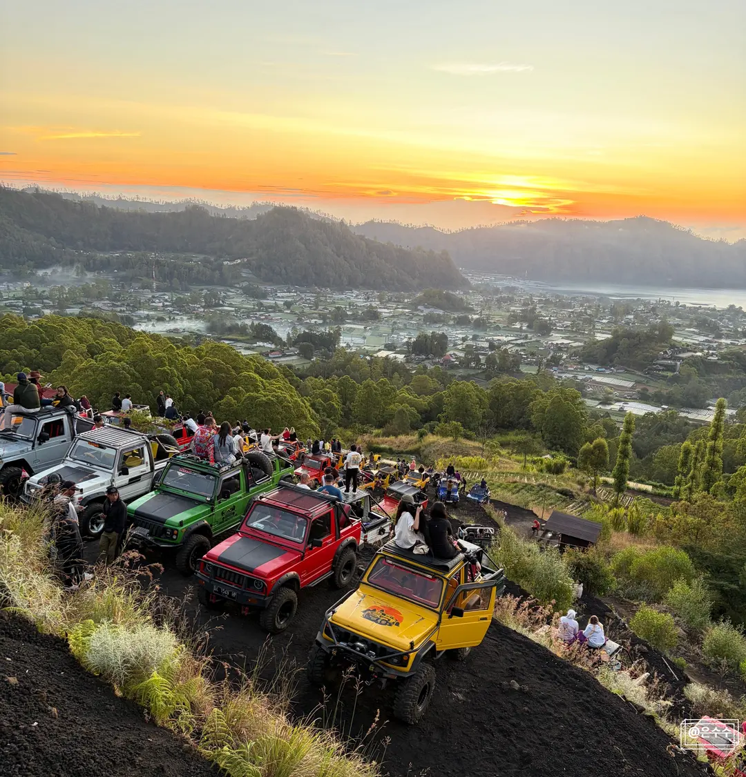 Tourists posing for photos with a jeep on Mount Batur