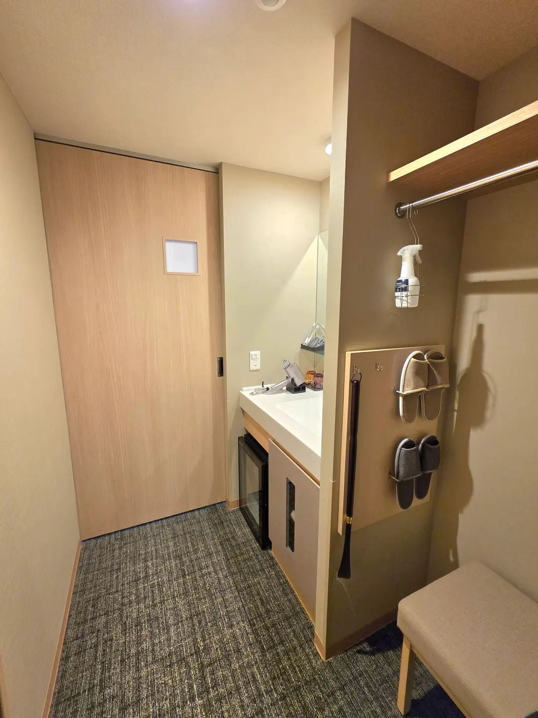 The bedroom is beyond the sliding door in the picture
