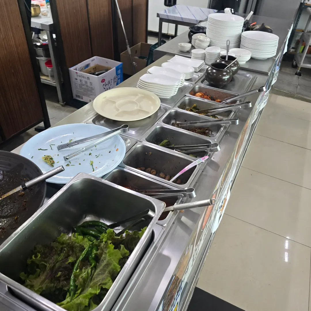 Variety of banchan including kimchi, namul, and jorim