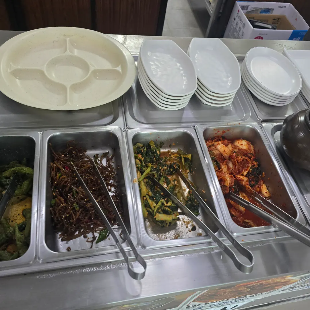 Stainless steel containers with side dishes and serving utensils