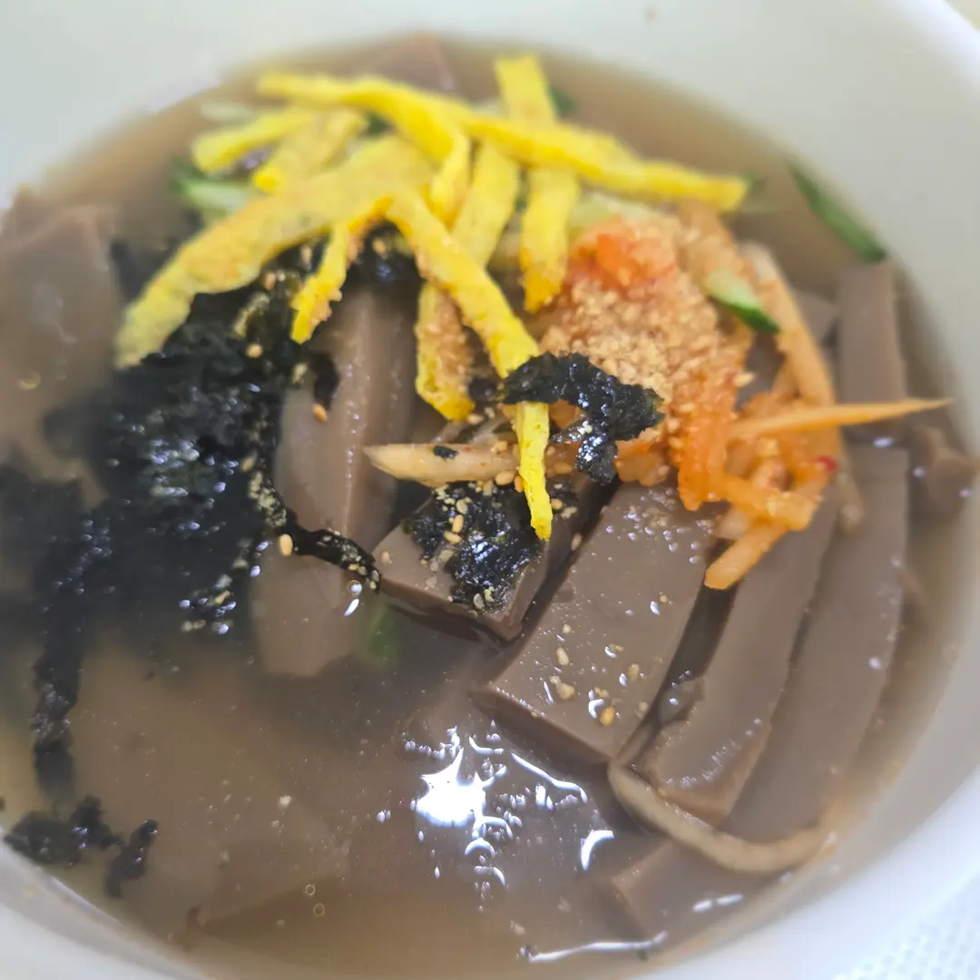 Close-up of Mukbap with acorn jelly and clear broth