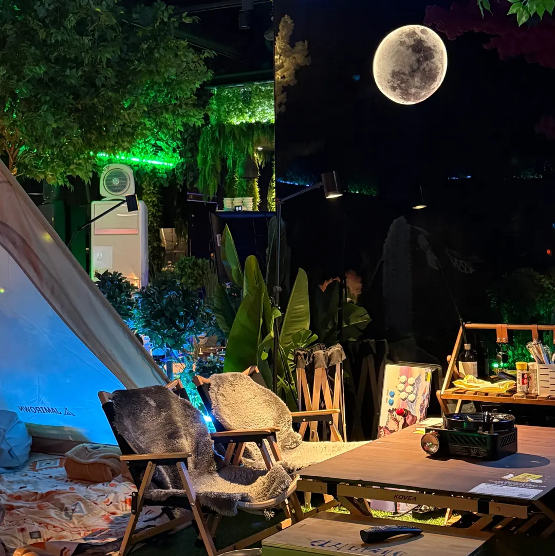Cozy indoor camping setup with tables and tents