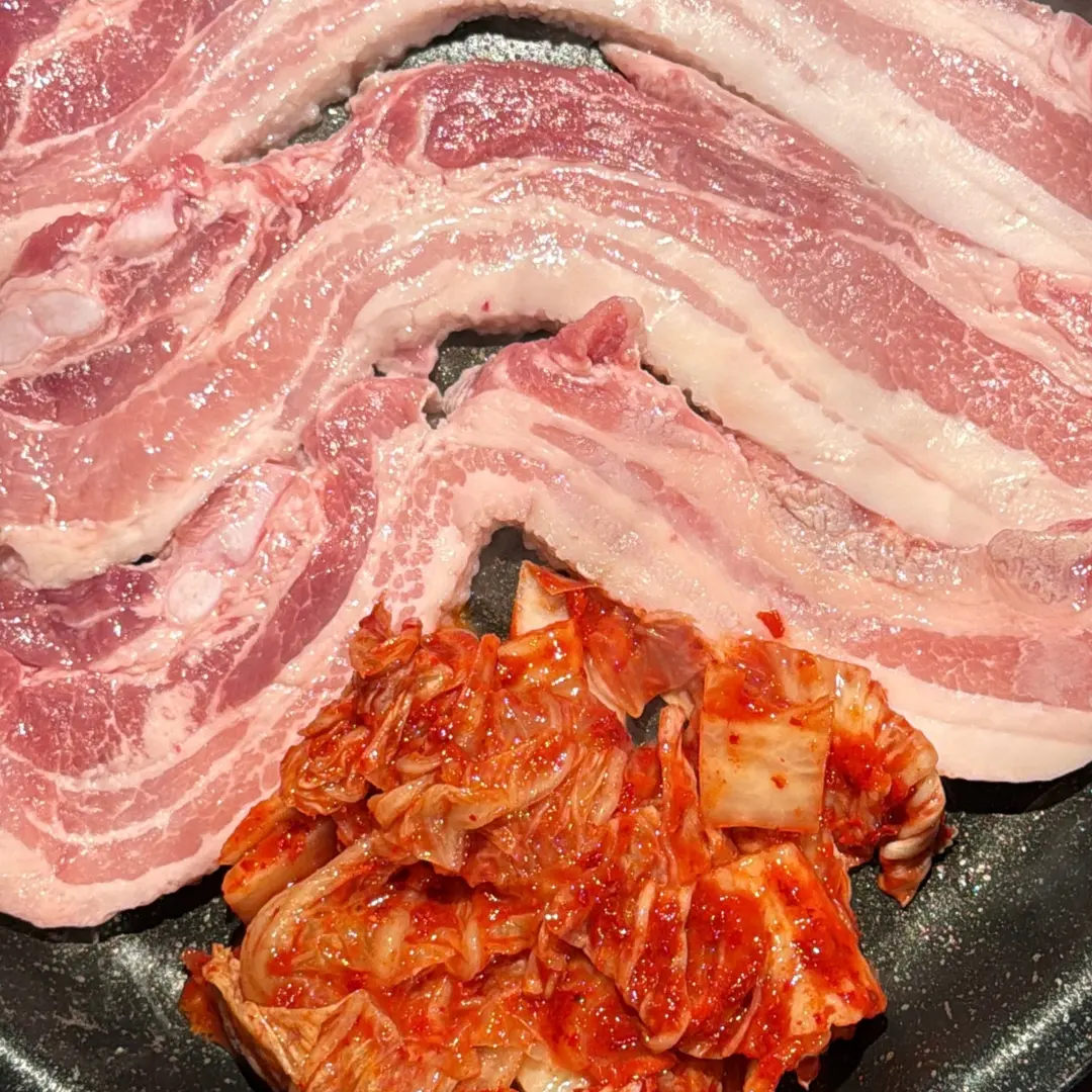 Pork belly, kimchi, and vegetables grilling
