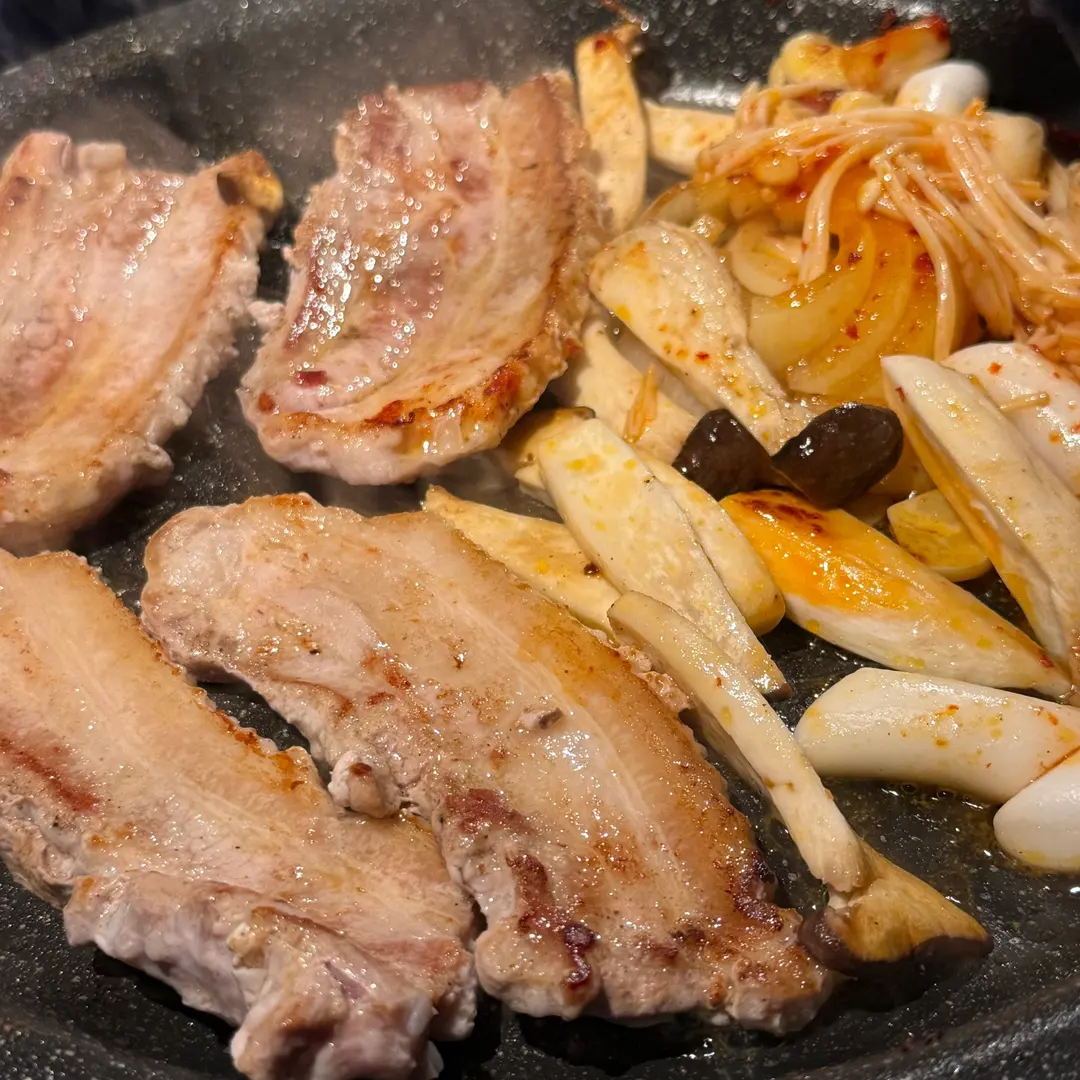 Grilled pork belly and sides on the hot plate