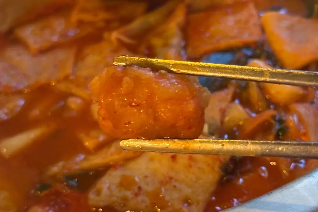 Fried items dipped into tteokbokki sauce