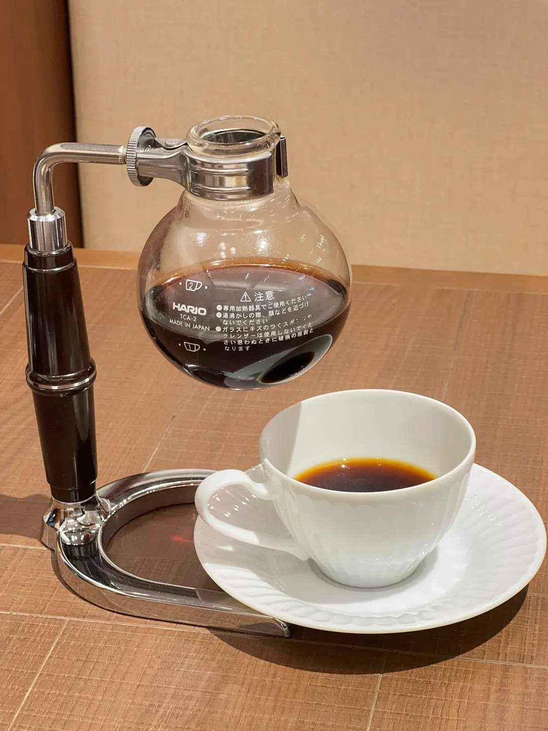 A delicious-looking cup of coffee with a side of dessert at Kurashiki Coffee.