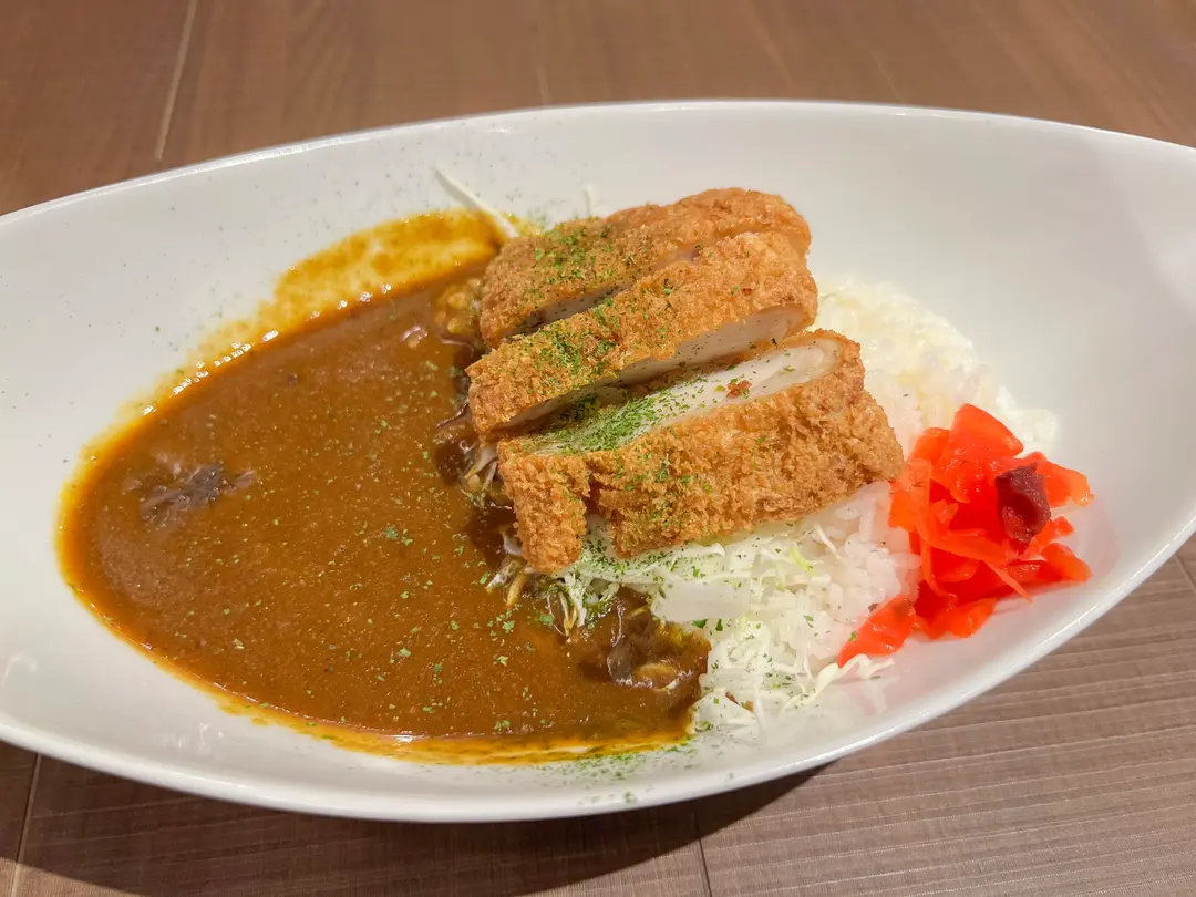 A hearty meal at Kurashiki Coffee, featuring a plate of tonkatsu (pork cutlet) with rice and salad.