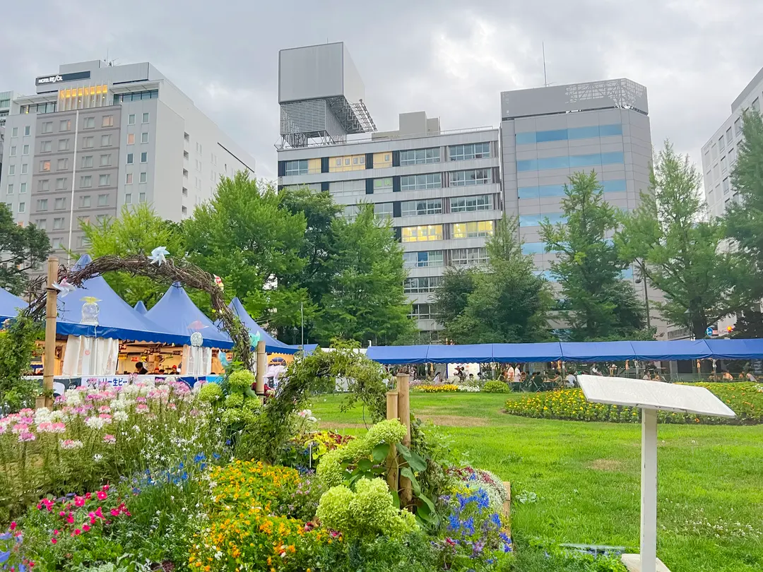 People enjoying beer and food at the Sapporo Beer Garden Festival in Odori Park.