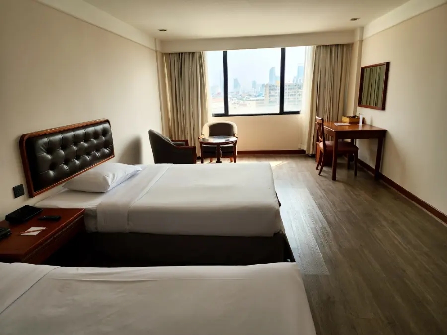 Hotel room with two large beds and city view