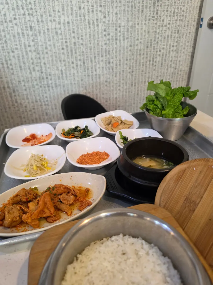 A full Korean meal with Jeyuk Ssambap and an array of side dishes, showcasing excellent value