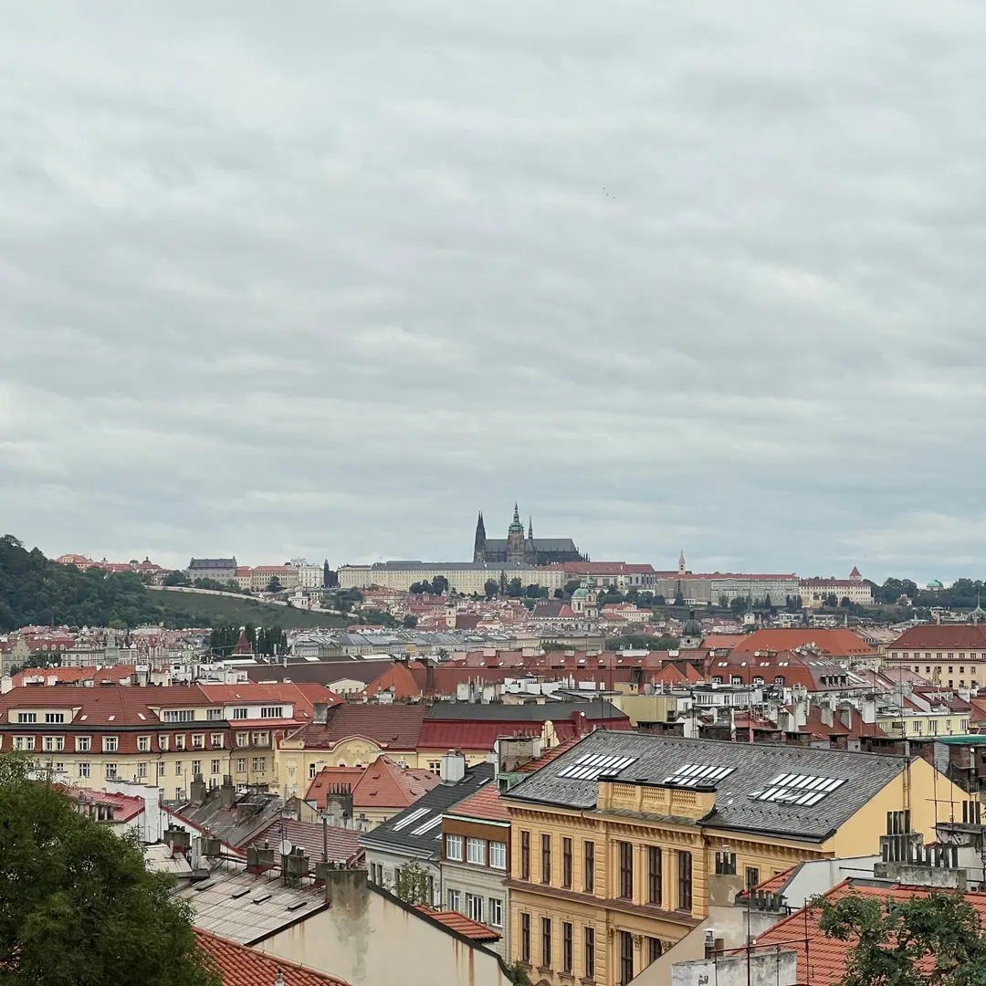 Red rooftops of Prague with Prague Castle in the distance from Vyšehrad
