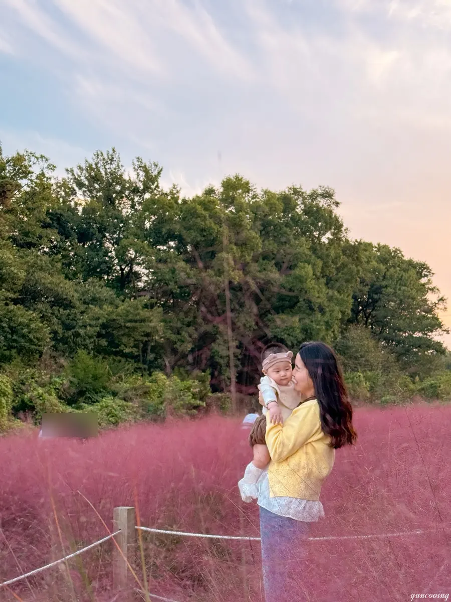 Baby smiling in pink muhly