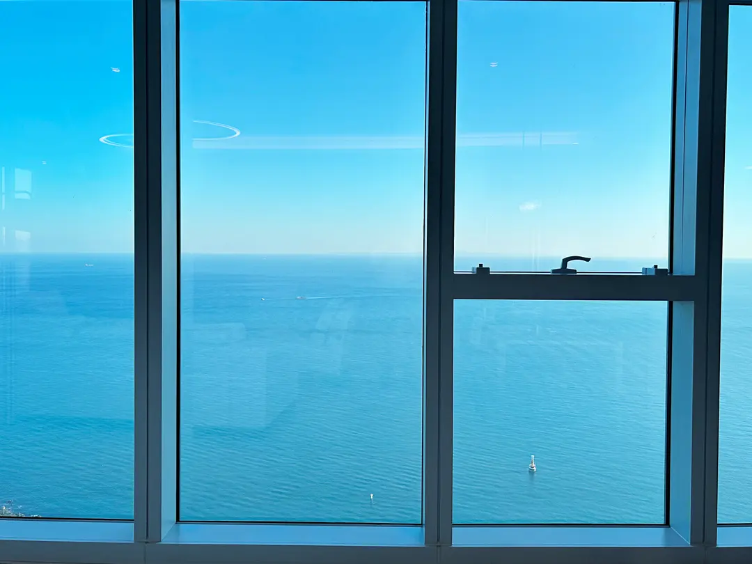 Opening the curtains reveals a stunning, unobstructed ocean view from the 90th floor