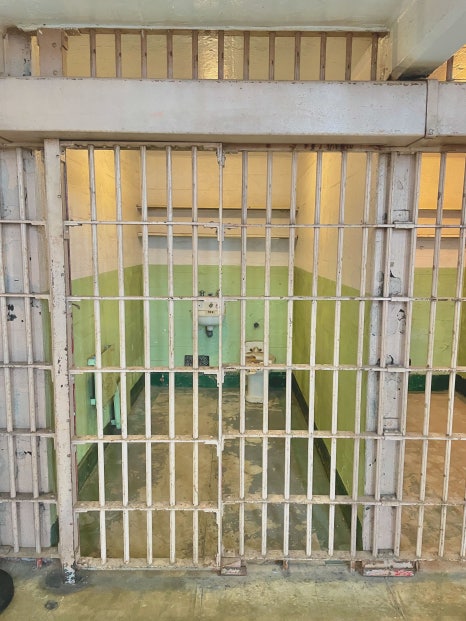 A foggy, atmospheric view of the Alcatraz Island prison buildings.