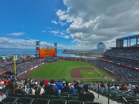Baseball players warming up on the field at Oracle Park.