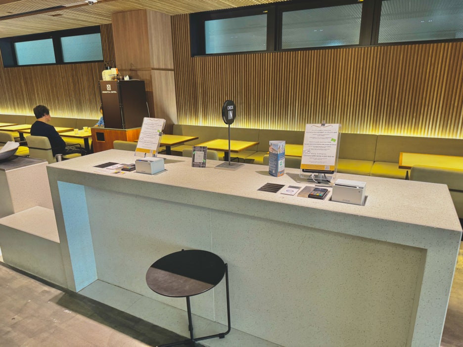 The bright and spacious hotel lobby with a self-check-in kiosk.