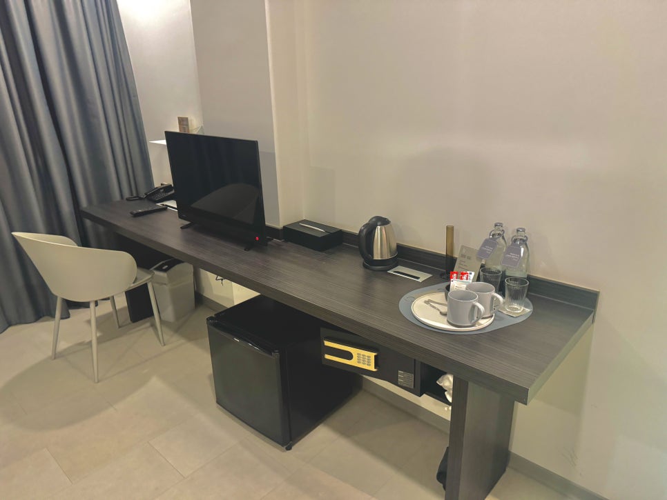 Desk area with TV and hidden mini-fridge